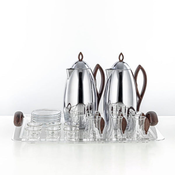 Silver tea set with glass cups on a white background