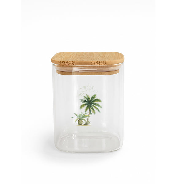 Clear glass jar with a wooden lid featuring palm tree designs on a white background