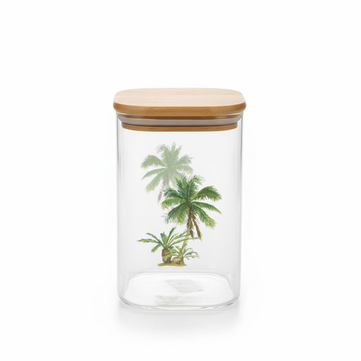 Clear glass jar with a wooden lid featuring palm tree designs on a white background