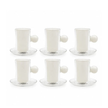 A clear glass coffee maker set with a white ceramic inner cup and saucer, a matching small white cup with a black clover logo, and a white spherical handle, photographed on a white background.