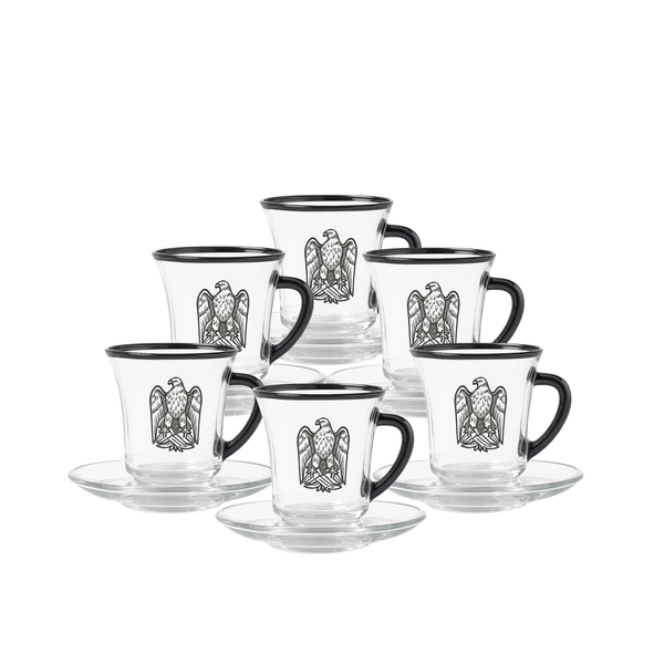 Set of glass mugs with black handles and decorative eagle emblem on a white background