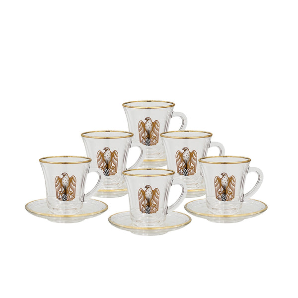 Set of six glass coffee cups with gold accents and saucers on a white background