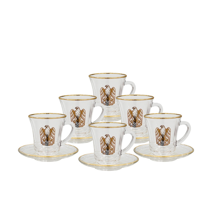 Set of six glass coffee cups with gold accents and saucers on a white background
