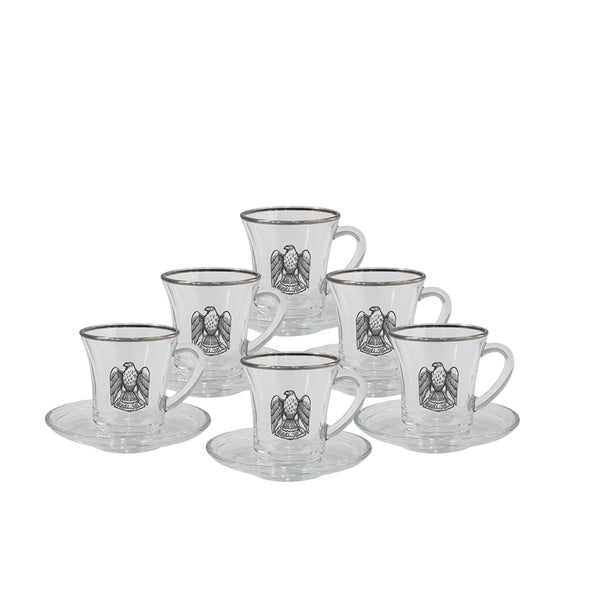 Set of six glass cups with saucers featuring an eagle emblem on a white background