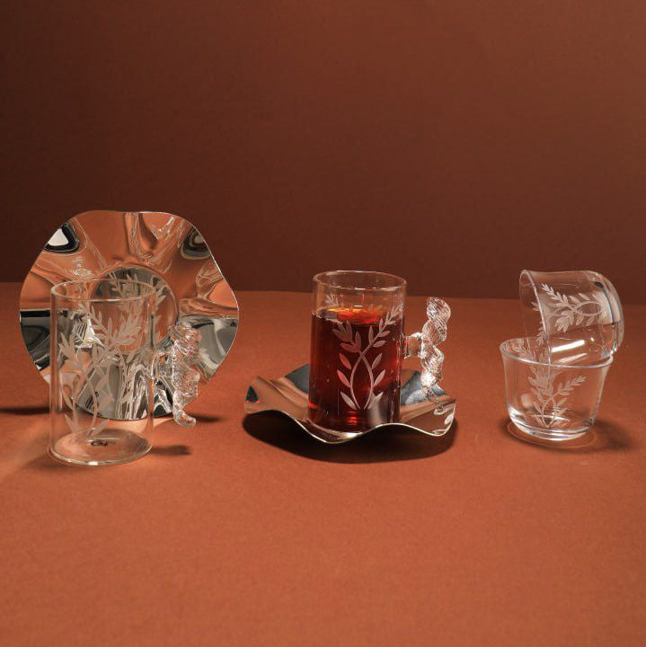 Set of crystal glasses on a brown surface with a plain background