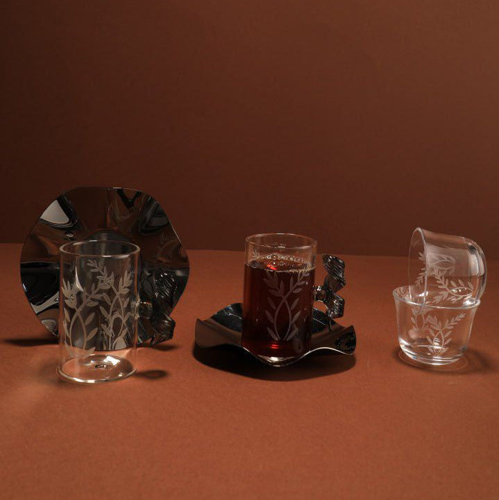 Set of glassware on a brown surface with a plain background