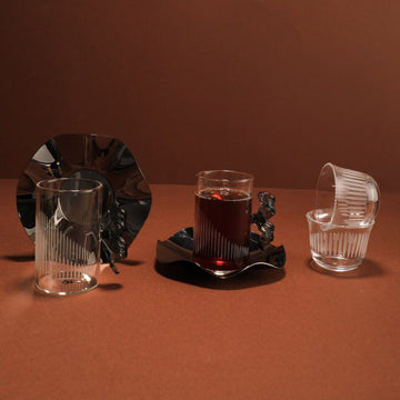 Set of glassware on a brown surface with a dark background