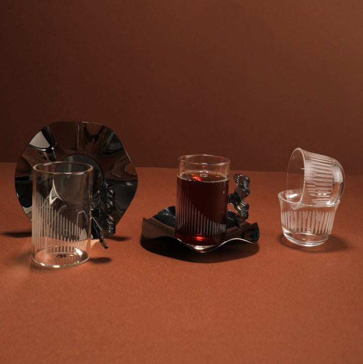 Set of glassware on a brown surface with a dark background
