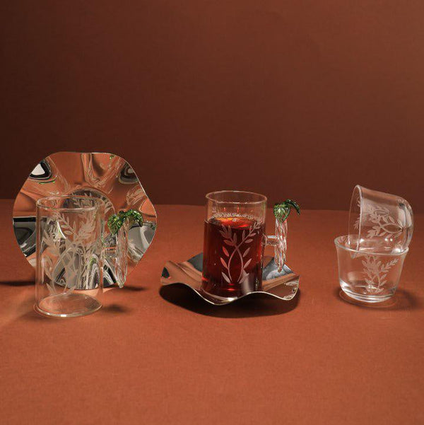Set of glassware on a brown surface with a plain background