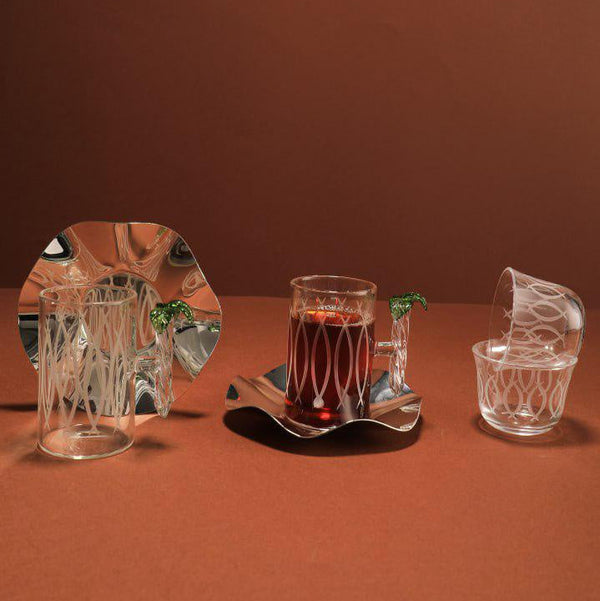 Set of crystal glasses on a brown surface with a plain background