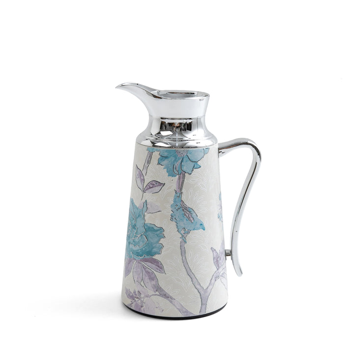 Decorative ceramic pitcher with floral design on a white background