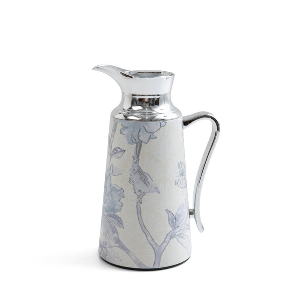 Decorative ceramic pitcher with floral patterns on a white background