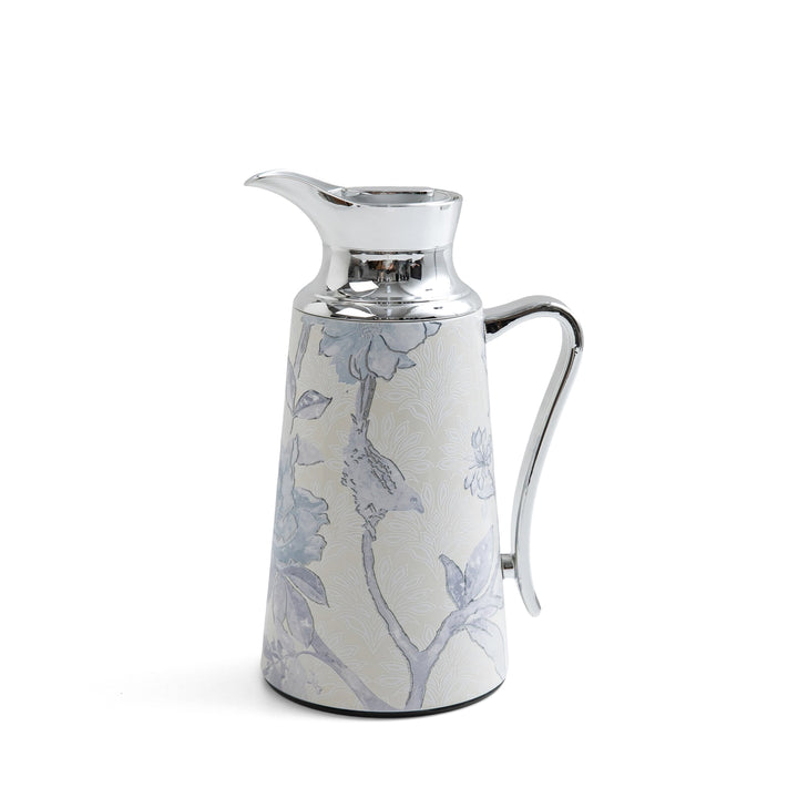 Decorative ceramic pitcher with floral patterns on a white background