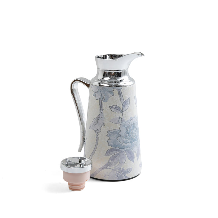 Ceramic carafe with floral design on a white background