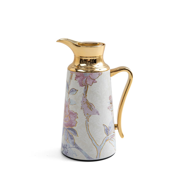 Decorative pitcher with floral design and gold accents on a white background