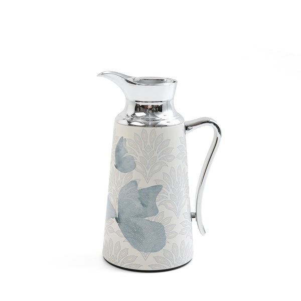 Decorative ceramic pitcher with floral patterns on a white background