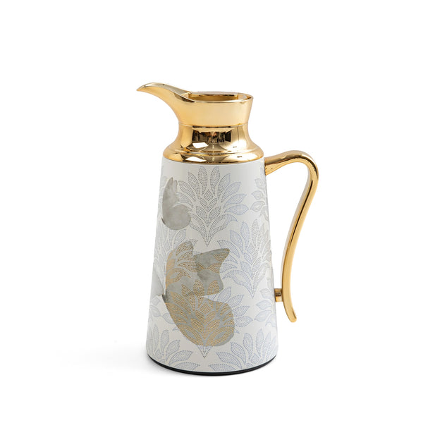 Decorative pitcher with gold accents on a white background