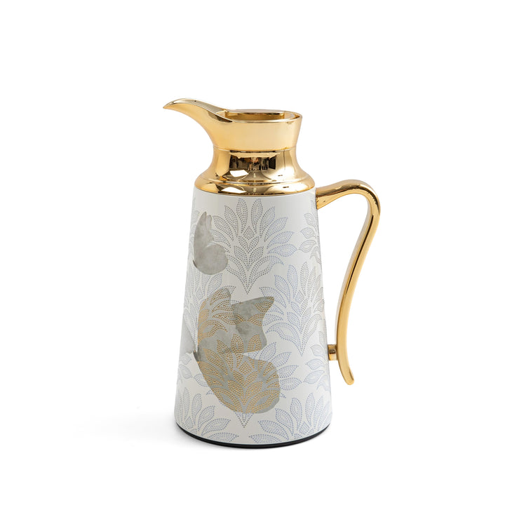 Decorative pitcher with gold accents on a white background