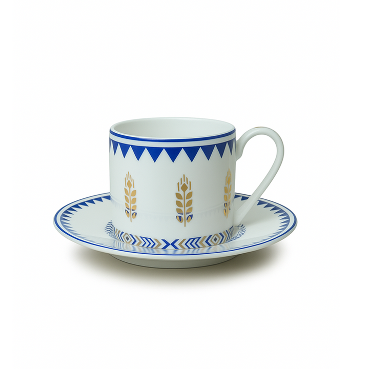 Ceramic cup and saucer with blue and gold design on a white background