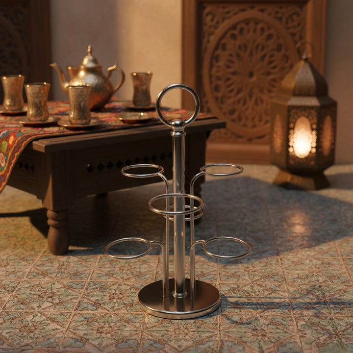 Metal drink holder on a patterned rug with a warm-toned background