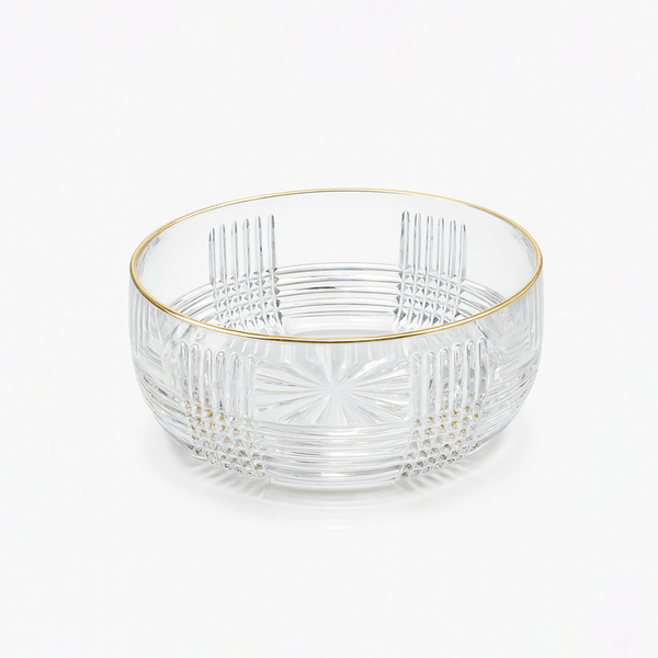 Clear glass bowl with gold rim on a white background