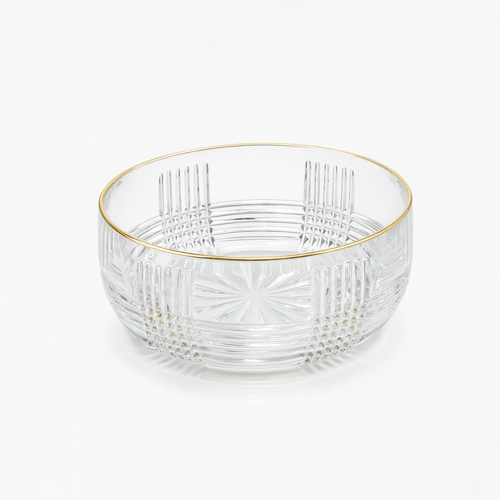 Clear glass bowl with gold rim on a white background
