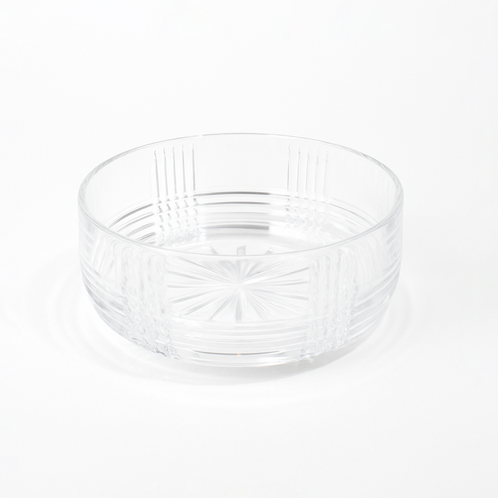 Clear glass bowl with textured design on a white background