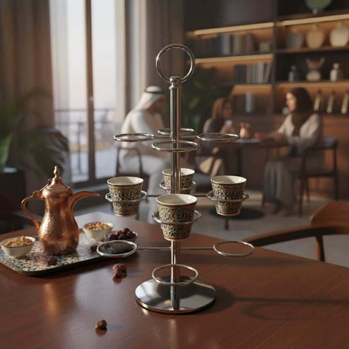 Café set with cups and a teapot on a wooden table, blurred background of people and decor.