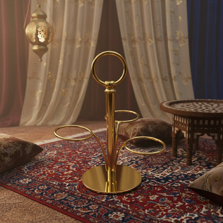 Gold decorative stand on a patterned rug with draped curtains in the background
