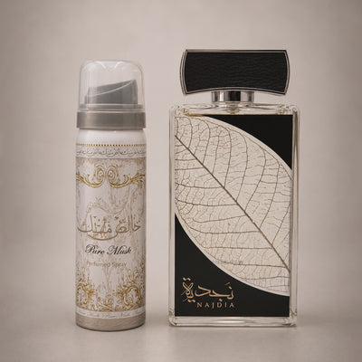 A perfume product shown in two containers: a cylindrical canister and a rectangular glass bottle, both labeled Najdia Pure Musk. The canister is white and silver with gold ornamental detailing, and the bottle has a black and white leaf design on the front.