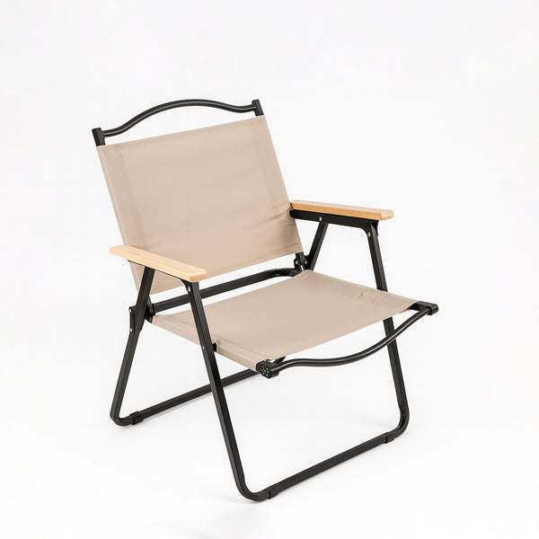 Beige folding chair with black frame on a white background