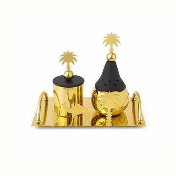 Gold and black decorative salt and pepper shakers with palm tree designs on a white background