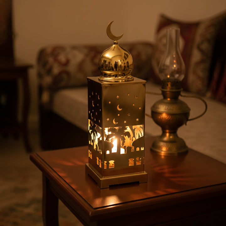Decorative lantern with a lit candle on a wooden table in a cozy room.