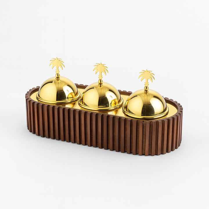 Decorative item with gold domes and palm tree figurines on a brown base