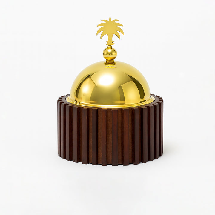 Decorative object with a gold dome and wooden base on a white background