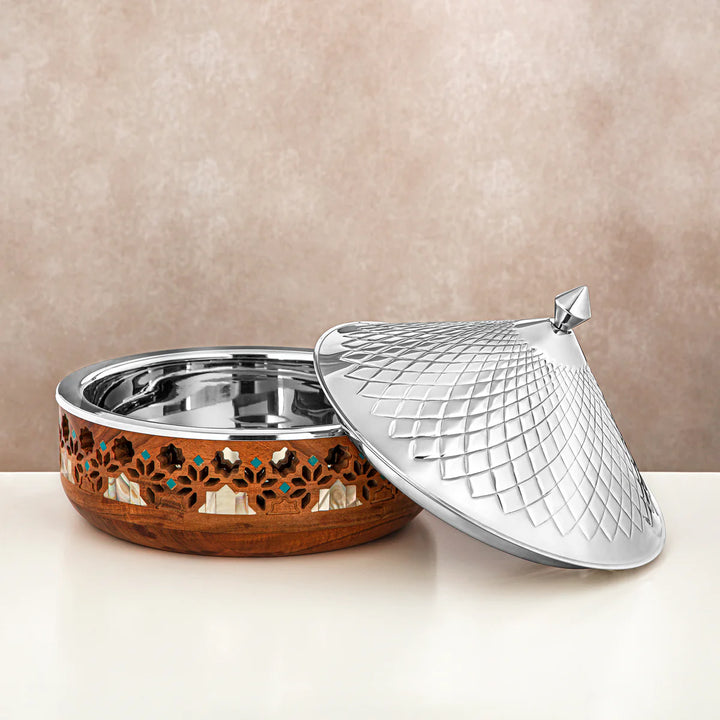 Decorative metal bowl with a textured lid on a beige background