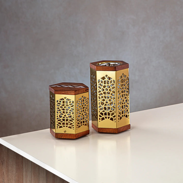 Two hexagonal lanterns with intricate designs on a neutral background