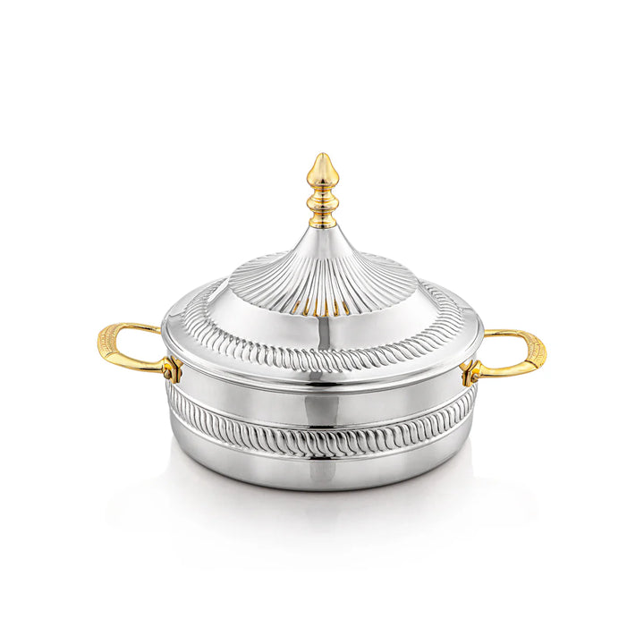 Silver dish with gold handles and decorative lid on a white background