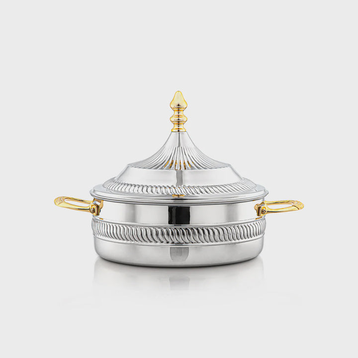 Silver pot with gold handles and decorative lid on a white background