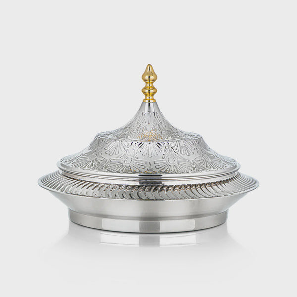 Decorative silver dish with a gold lid on a white background
