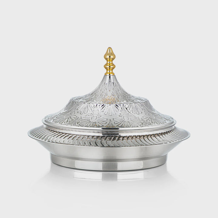 Decorative silver dish with a gold lid on a white background