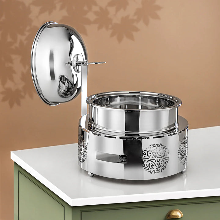 Silver decorative item on a white surface with a brown background