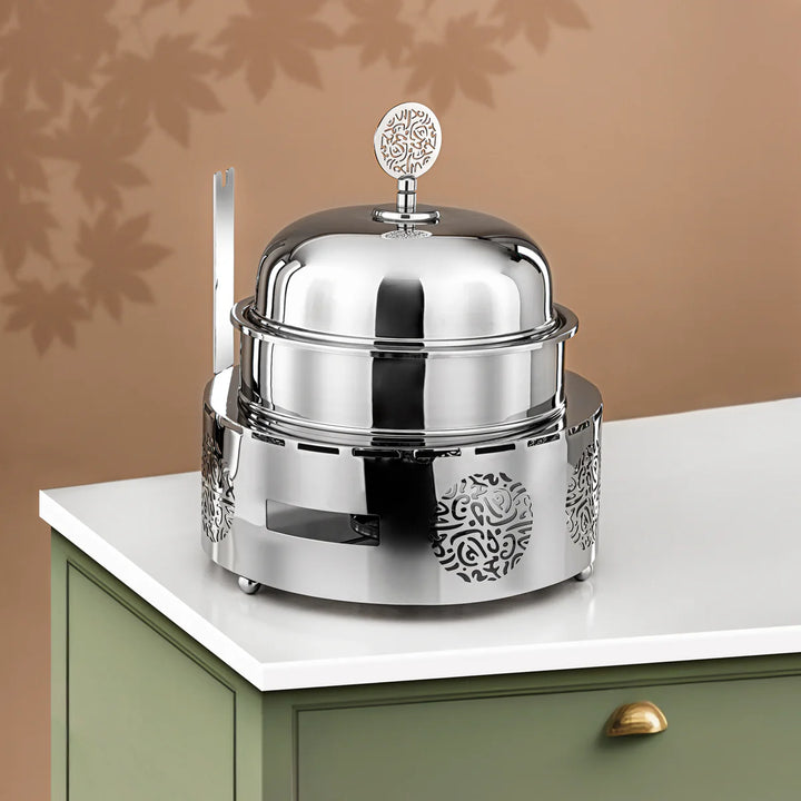 Silver decorative object on a white surface with a brown background