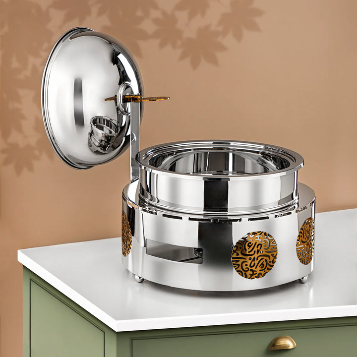 Stainless steel pot with decorative elements on a beige background