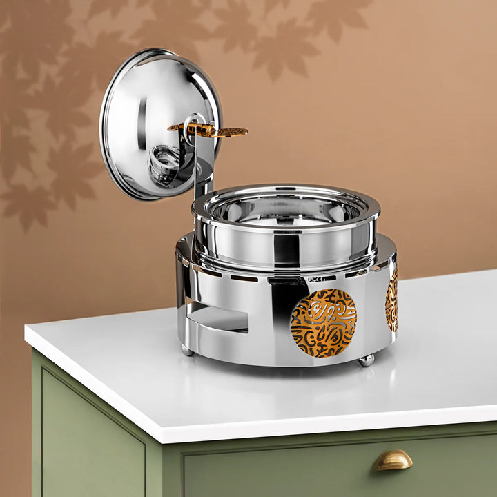 Silver and gold decorative item on a white surface with a brown background