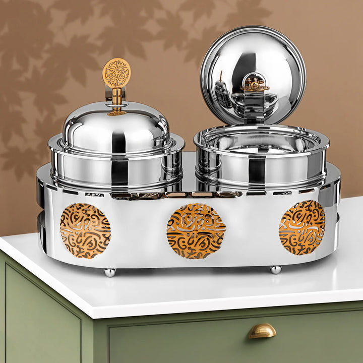 Silver and gold decorative container on a white surface with a brown background