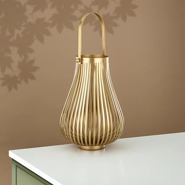 Gold lantern on a white surface with a brown wall background
