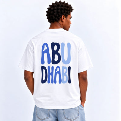 Men’s Abu Dhabi Graphic T-Shirt In White With A Stylish Abu Dhabi Inspired Design, Short Sleeves, Crew Neck, And Comfortable Regular Fit At Siddiq Gifts.