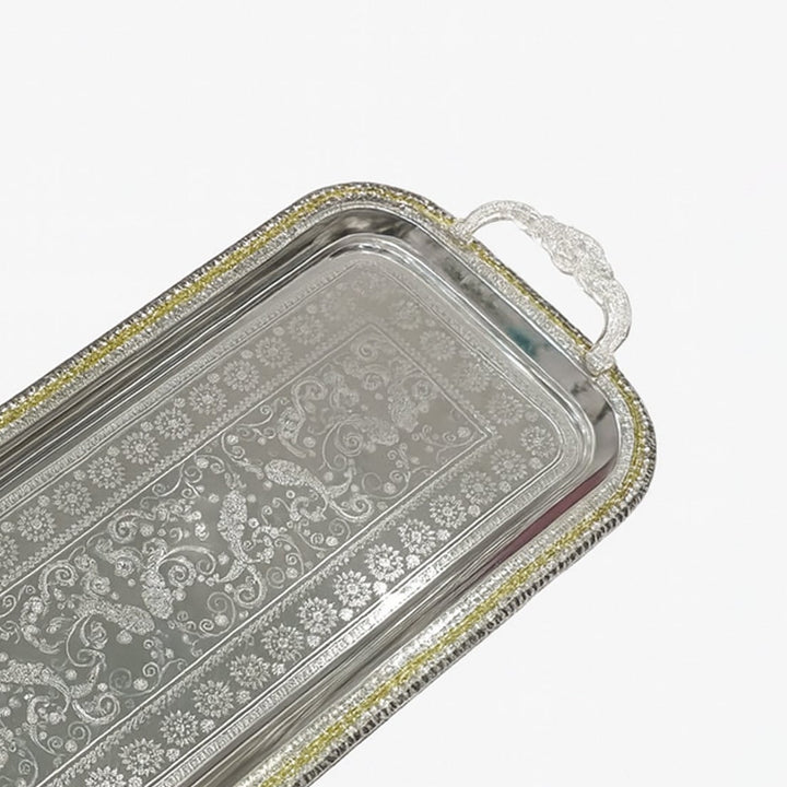 Decorative silver tray with intricate patterns on a white background