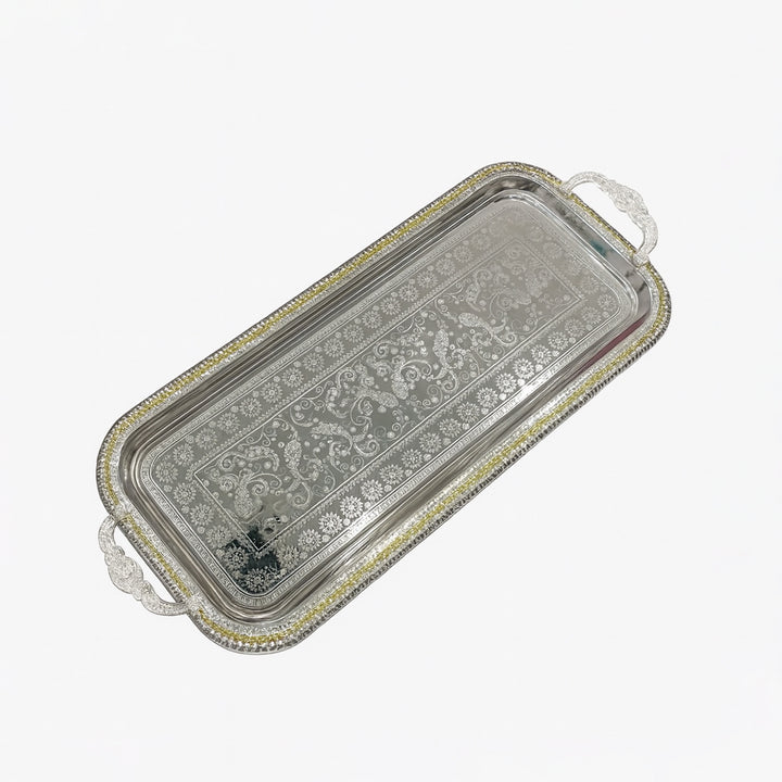 Decorative silver tray with intricate patterns on a white background